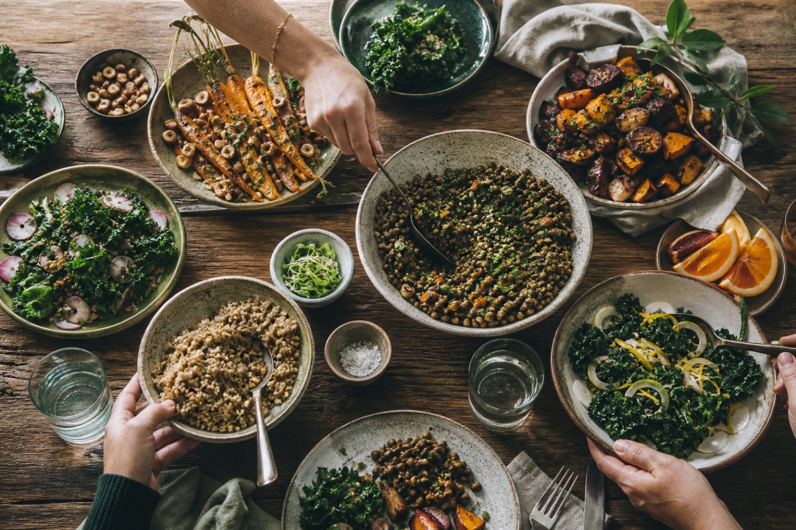 A shared table filled with colorful plant-forward dishes